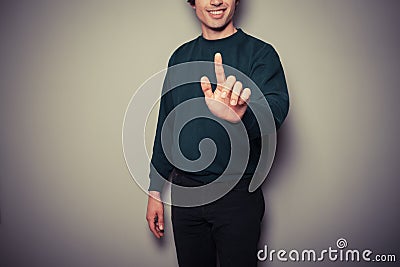 Young man pointing or pushing button