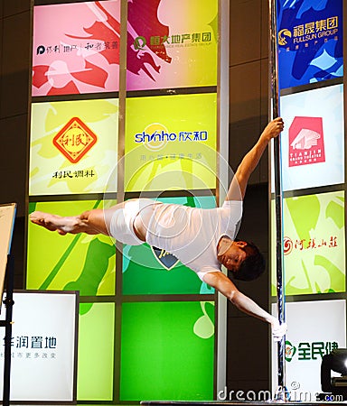 Young man pole dance