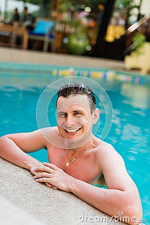 Young man posing in the swimming pool