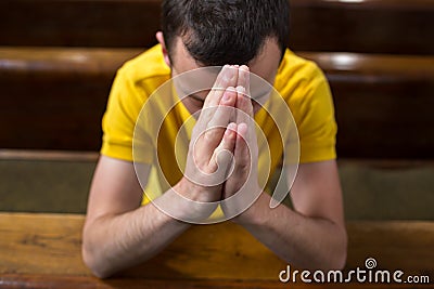 Young man praying in a church