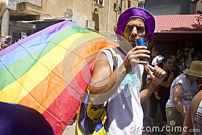Young man with rainbow flag at Pride Parade TA