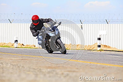 Young man riding big bike motorcycle on sharp curve asphalt road