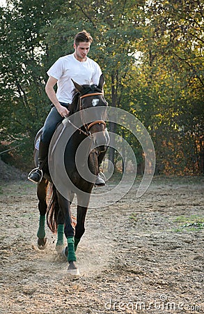 Young man riding Horse
