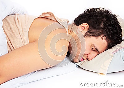 Young man sleeping in bed