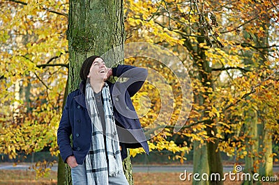 Young man smiling outdoors in the countryside on a autumn day