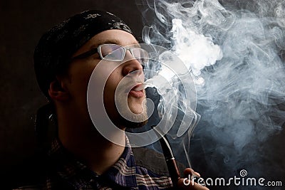 Young man smoking pipe