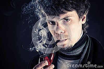 Young man smoking a pipe