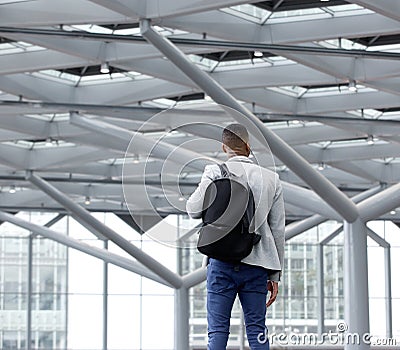 Young man standing in empty airport