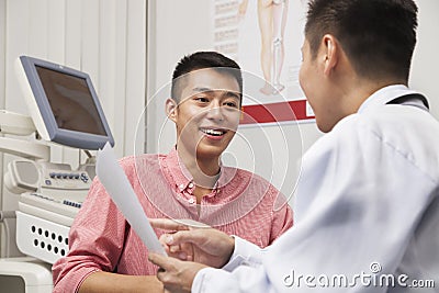Young Man Talking With Doctor