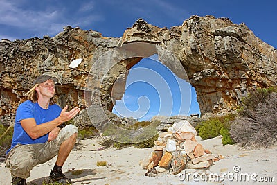 Young man tosses a rock