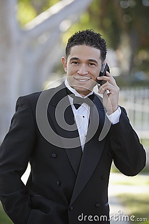 Young Man In Tuxedo Using Cell Phone at Quinceanera
