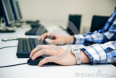 Young man typing on keyboard.