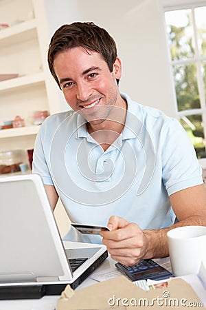 Young man using credit card on the internet