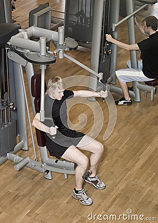 Young man using an exercise machine