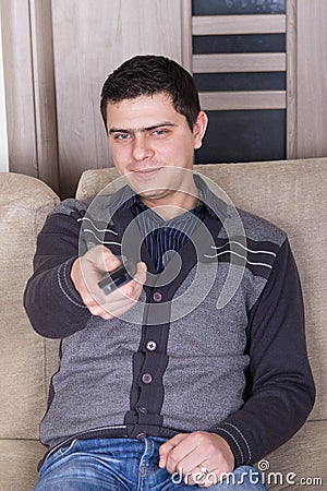 Young man watching TV at home