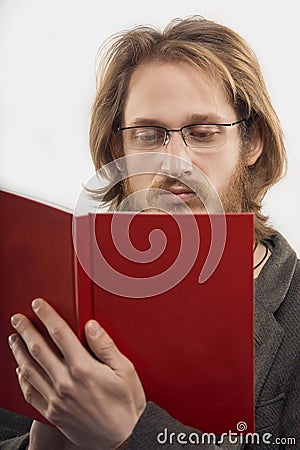 Young man wearing glasses reading a book