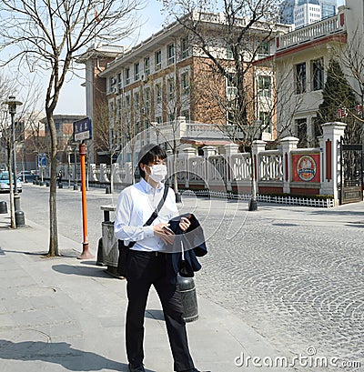 Young man wearing mask walking in the street