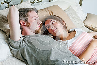 Young man and woman in bed.