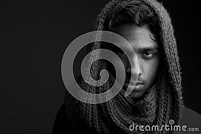 Young man with wool scarf covering head