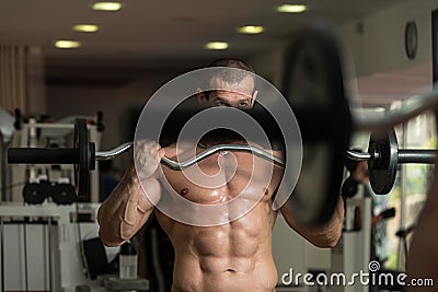 Young Man Working Out In A Health Club