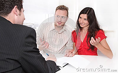 Young married couple at desk in a business meeting
