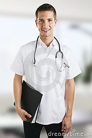 Young medical doctor man with stethoscope and folder in the hospital.