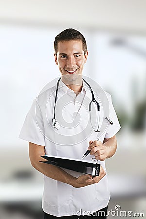 Young medical doctor man with stethoscope writting on notebook in the hospital.