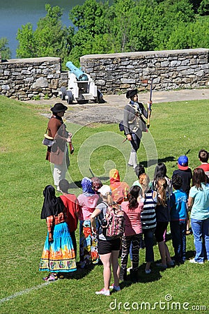 Young men in soldier s uniform, educating tour group on the history of Fort Ticonderoga,New York,2014