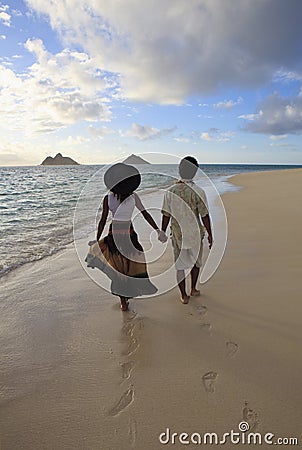 Young mixed couple walk on a beach