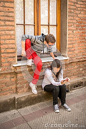 Young modern couple sharing mobile information