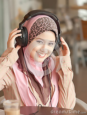 Young muslim women wearing head phone