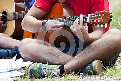 Young people playing guitar together