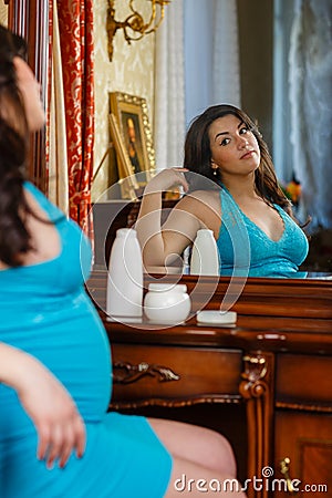 Young pregnant woman with cosmetic cream.