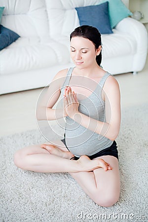 Young pregnant woman do yoga