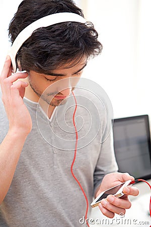 Young relaxed man listenning music at the office