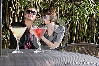Young romantic couple having drinks on patio