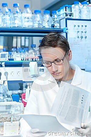 Young scientist or tech works in modern lab