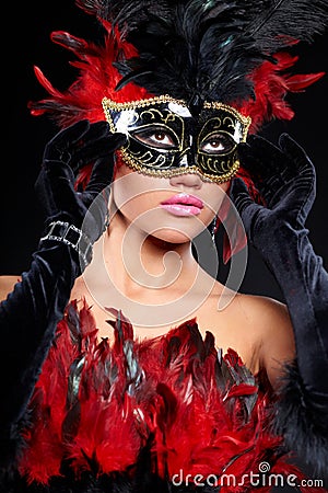 Young sexy woman in black party half mask