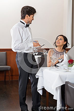 Young smiling couple at the restaurant
