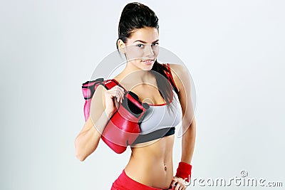 Young smiling fitness woman standing with boxing gloves