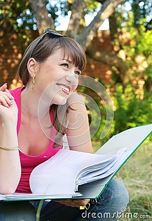 Young smiling girl with an open folder