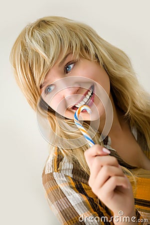 Young smiling girl with sugar candy