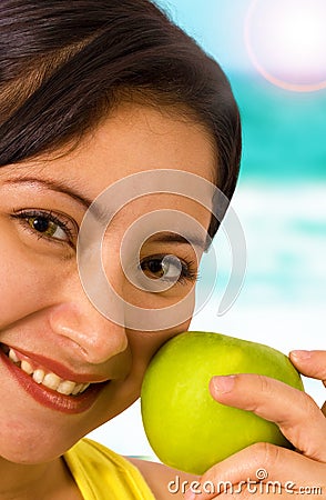 Young Smiling Lady At The Beach Holding An Apple