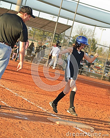 Young Softball Player Running to Base