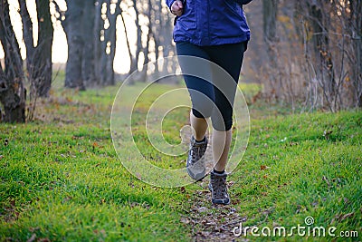 Young Sports Woman Running on the Forest Trail in the Morning