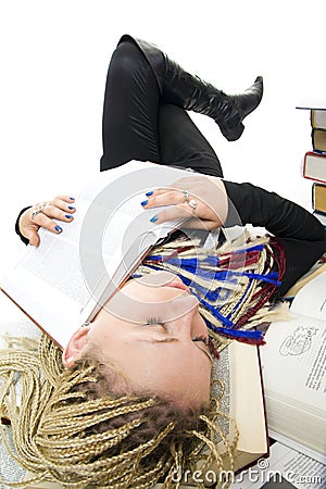 The young student sleeps on books