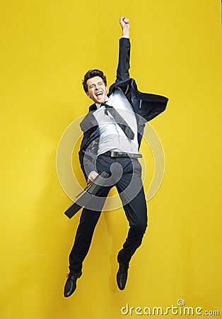 Young succesful businessman in the victory jump