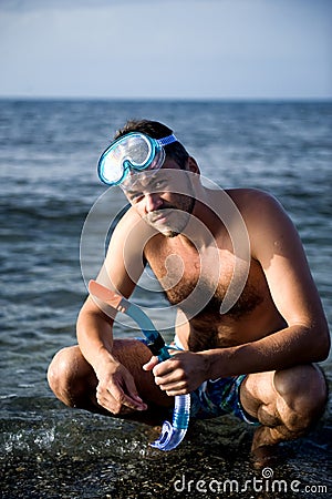 Young summer diving man with swimming mask