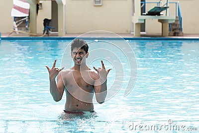 A young swimmer poses in swimming pool