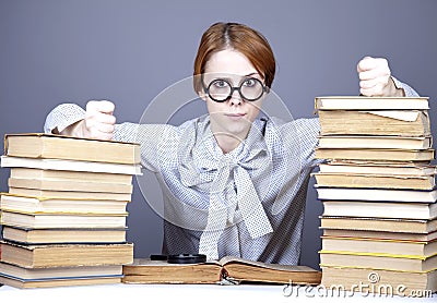 The young teacher in glasses with books.